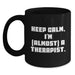 Funny Therapist Gifts from Friends for Graduation Unique Black Coffee Mug - 'Keep Calm, I'm almost A Therapist.' - Main